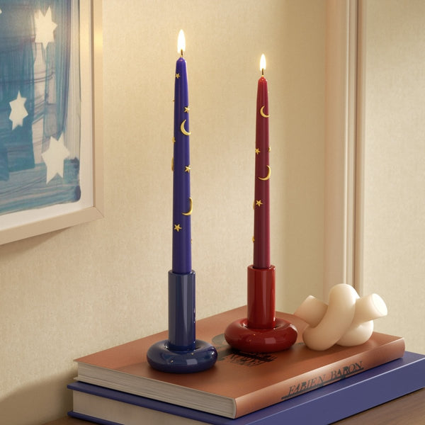 Lit blue and red candles adorned with gold crescents and stars, set in glossy holders - Boowan Nicole