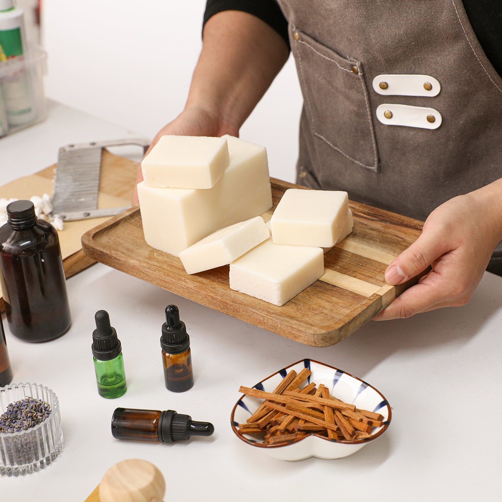 Creamy white Milk Cleansing Essential Oil Soap Bars on a wooden tray with botanical ingredients - Boowan Nicole