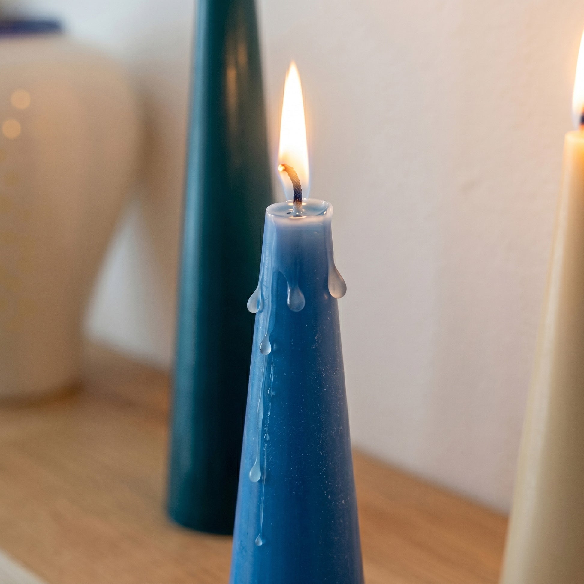 Close-up of Lit Conical Candle with Melting Wax - Boowan Nicole