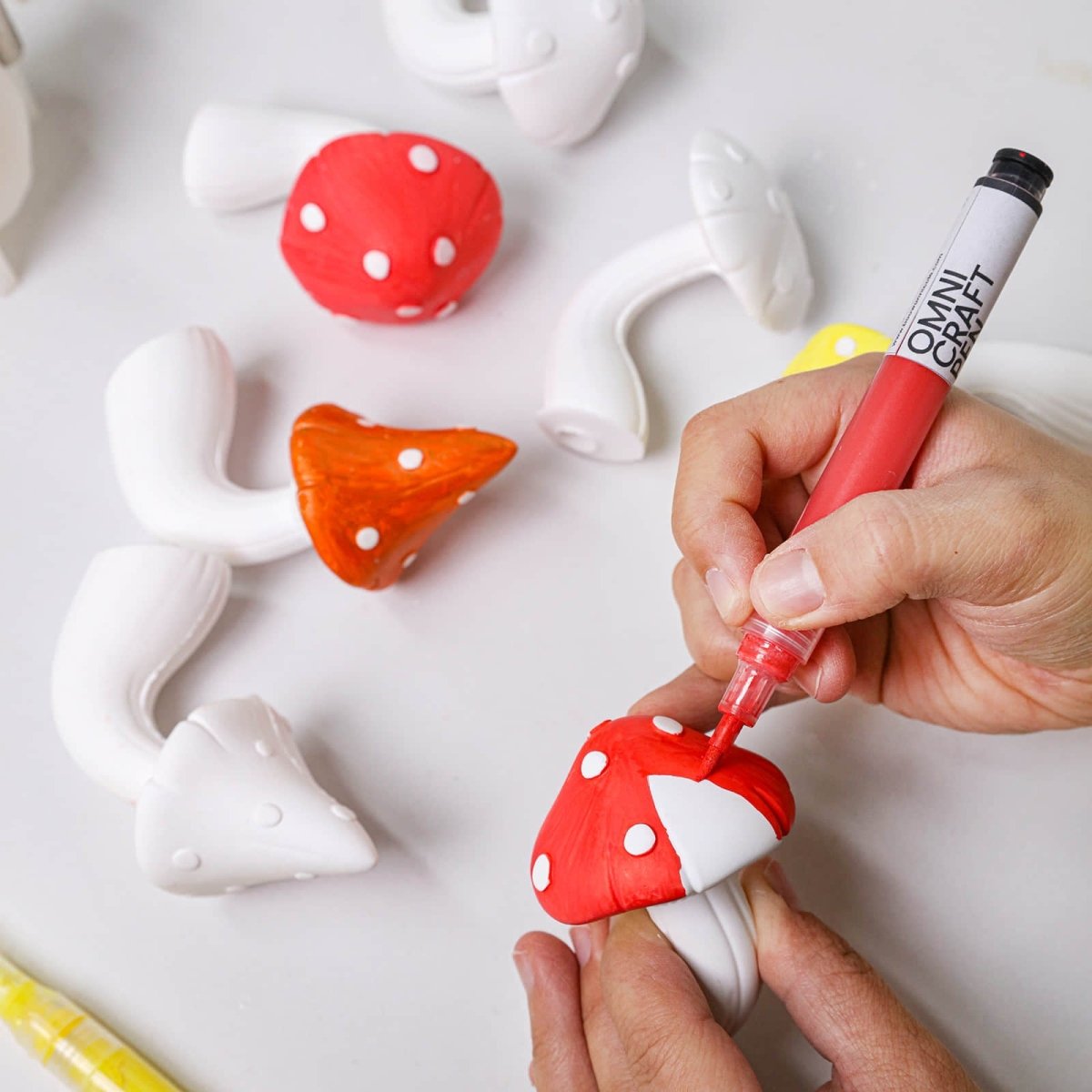 Hand-painting a red mushroom cap wall hook with white dots - Boowan Nicole