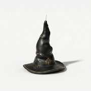Matte black twisted wizard hat pillar candle with gold maple leaf emblem & crackle gold foil detail plain white background product shot - Boowan Nicole