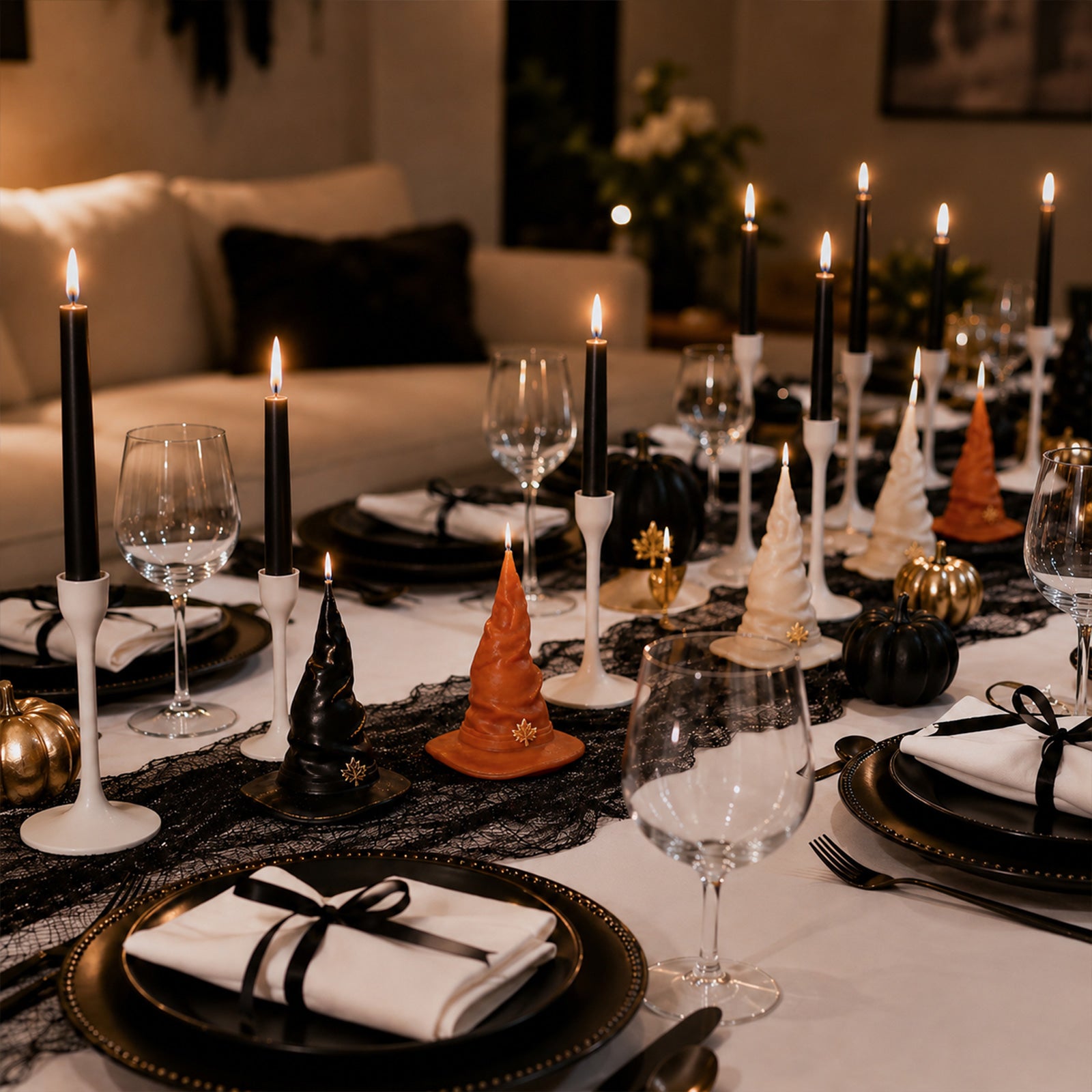 Full collection black, orange, cream wizard hat candles paired with taper candles & mini pumpkins Halloween formal dinner table layout - Boowan Nicole