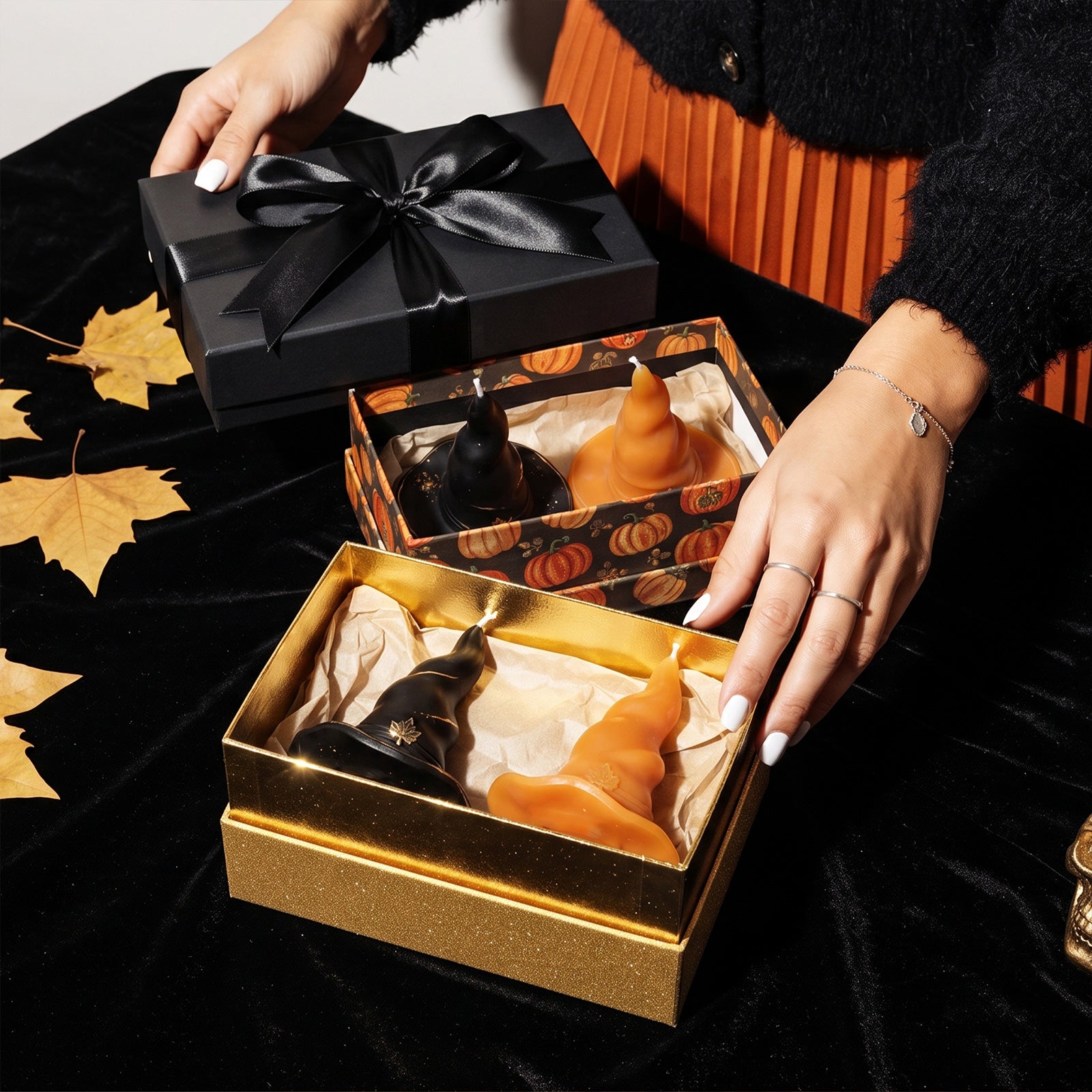 Luxury black satin ribbon gift box set with black & orange maple leaf wizard hat candles fall Halloween present flat lay - Boowan Nicole