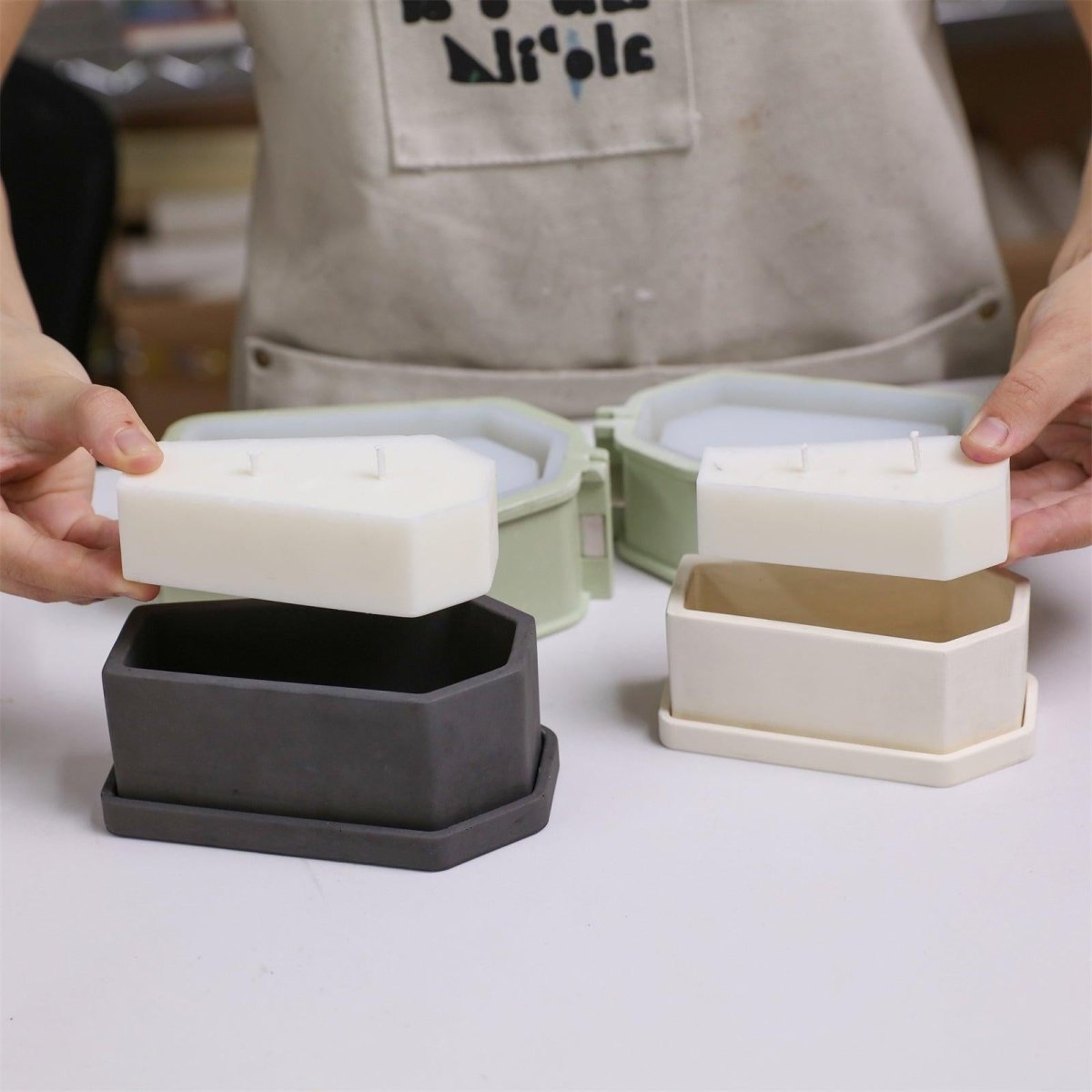 Placing finished candle refills into candle jars - Boowan Nicole