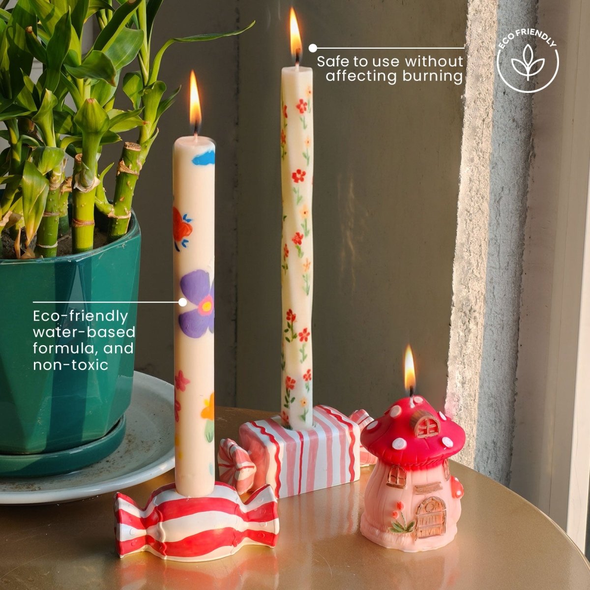 Decorated taper candles and a mushroom house candle burning, painted with Omni Craft Pen eco-friendly water-based non-toxic ink safe - Boowan Nicole