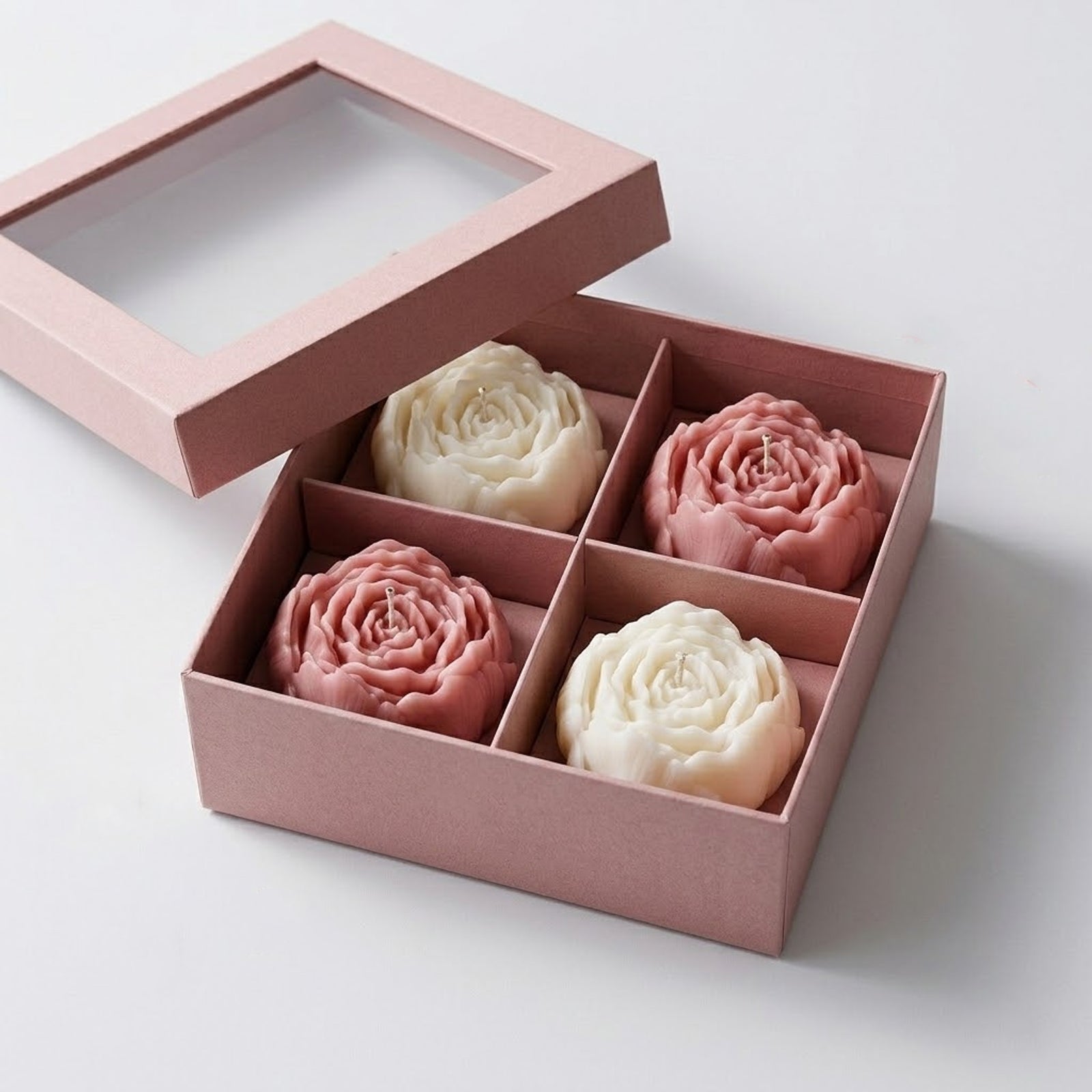A set of four peony candles (pink and white) in a pink gift box with a clear window, ready for gifting. -Boowan Nicole