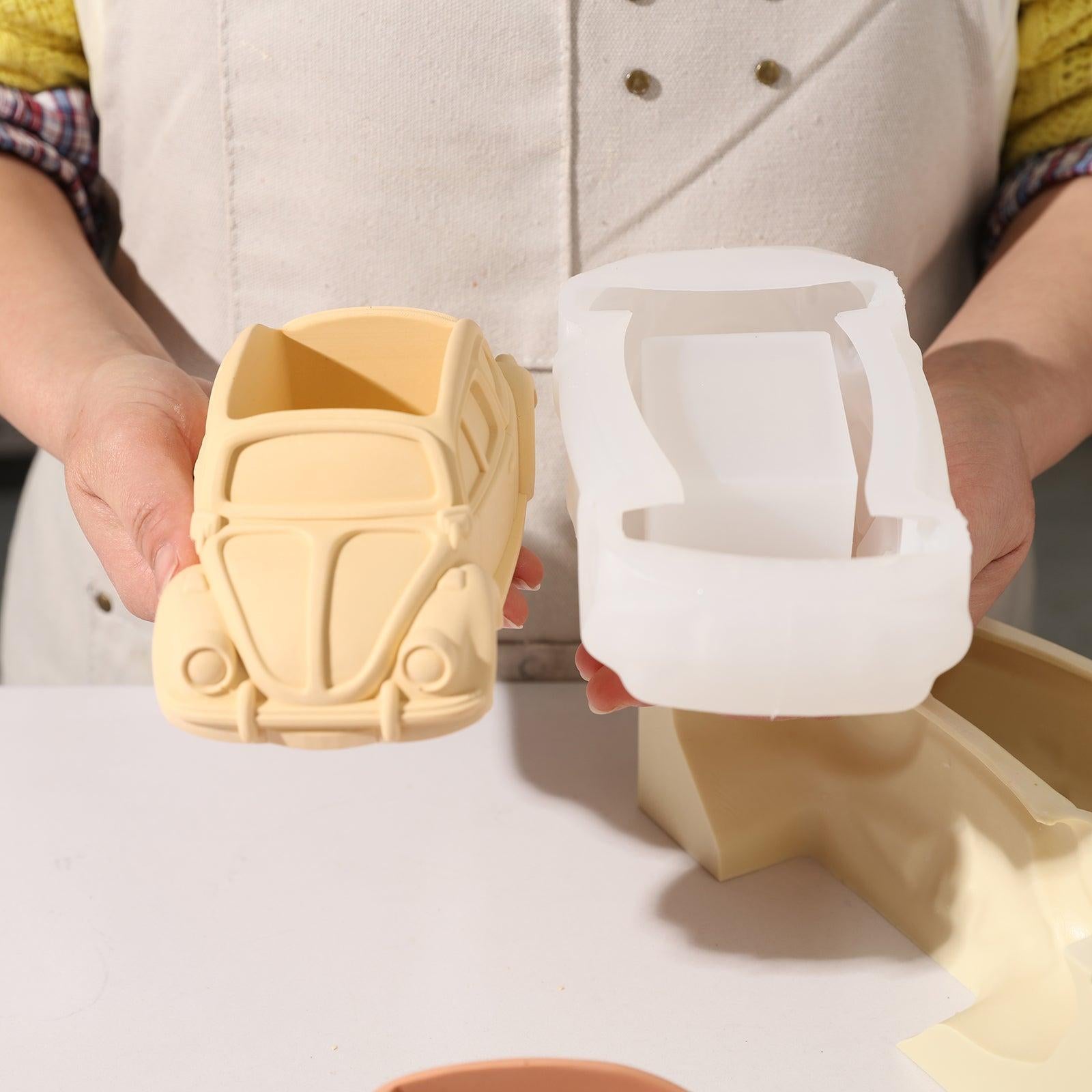 Hand-held display of silicone molds and finished plant pots.