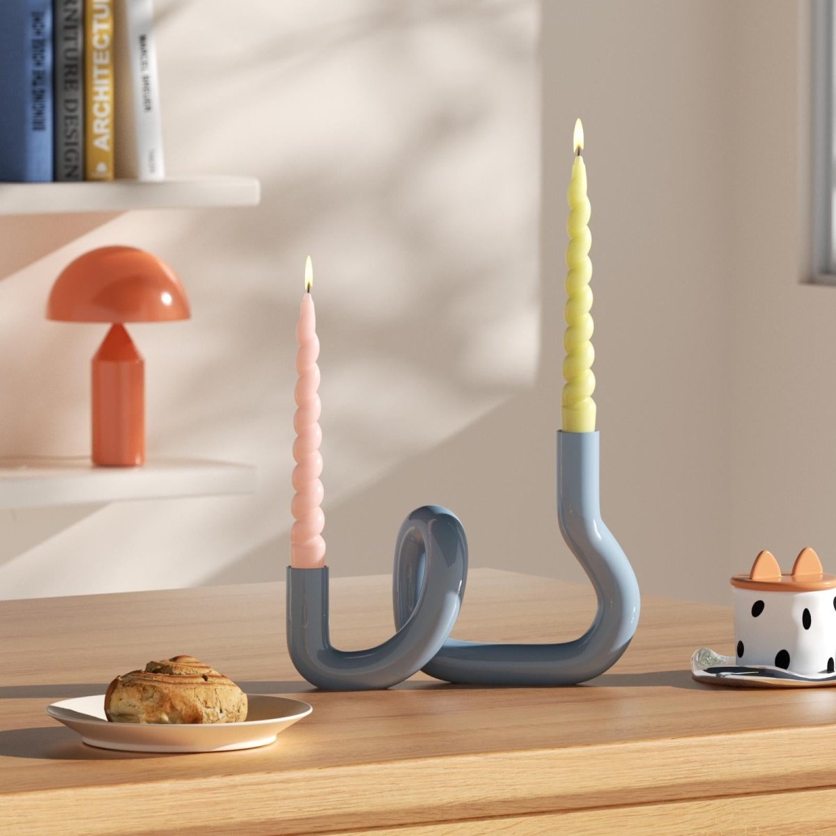 Yellow and pink twisted taper candles in a modern, curved candle holder, adding a playful and stylish touch to your home decor-Boowan Nicole