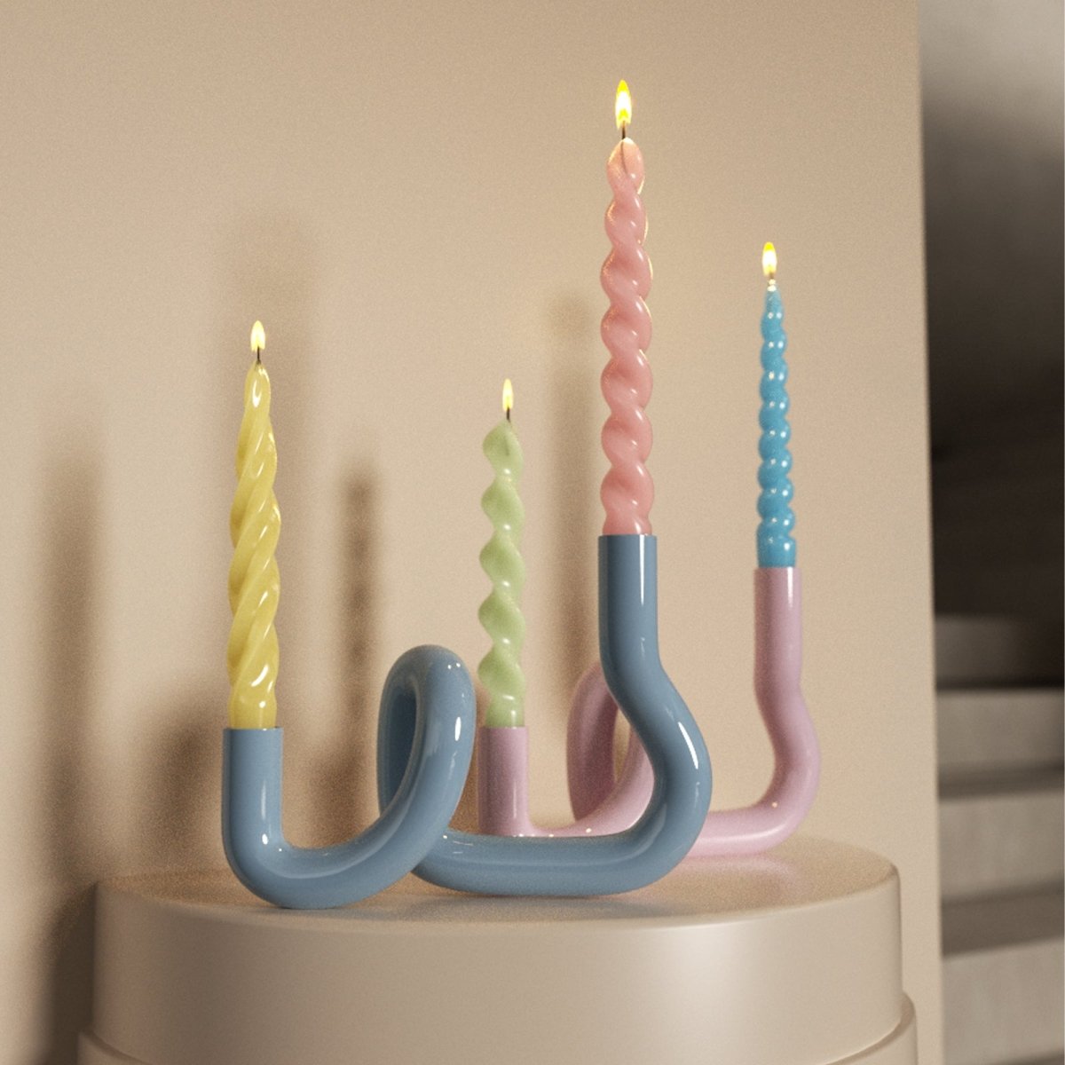 Colorful taper candles in a modern, curved candle holder, adding a playful and stylish touch to your home decor-Boowan Nicole