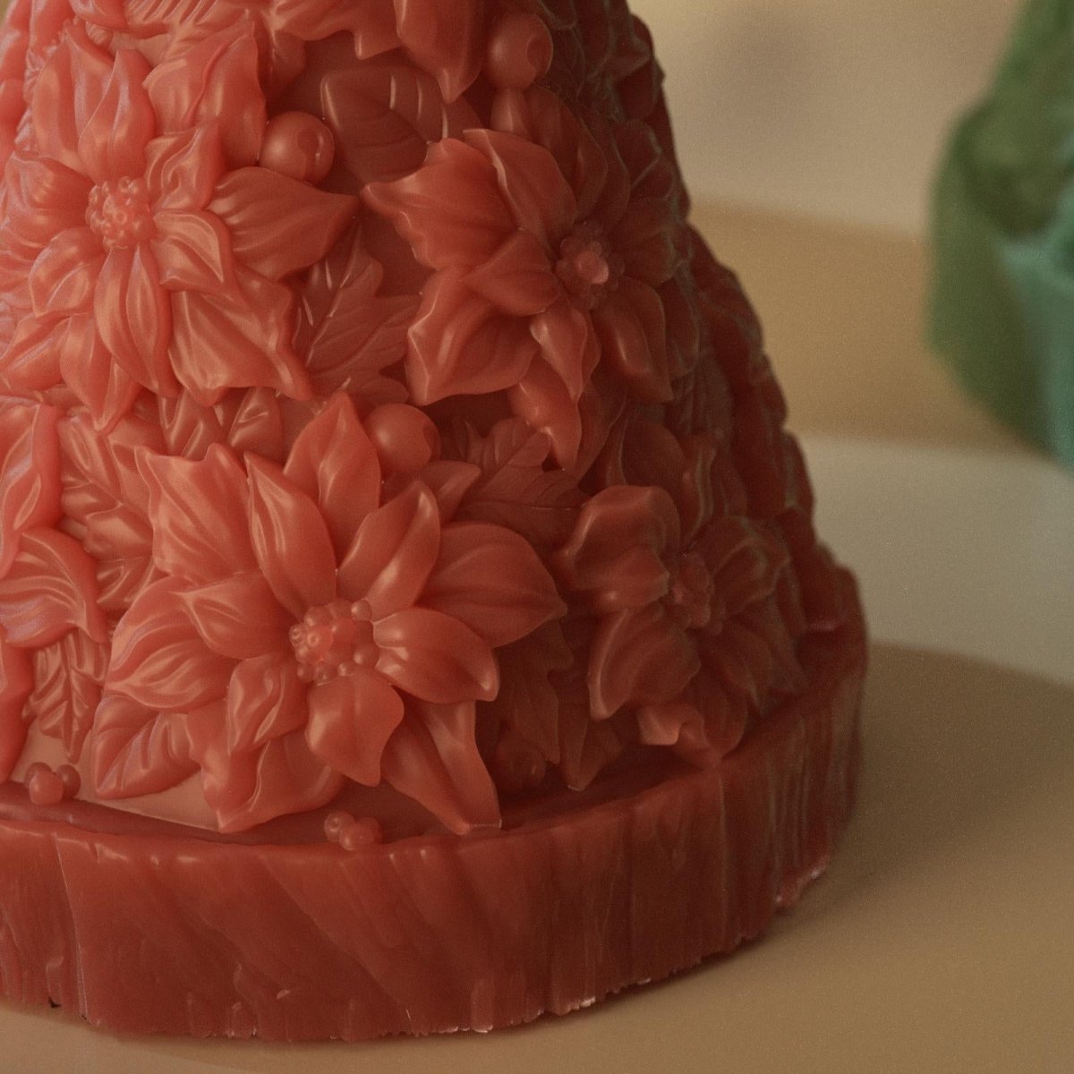 Close-up of red Christmas tree candle featuring detailed poinsettia flower texture - Boowan Nicole