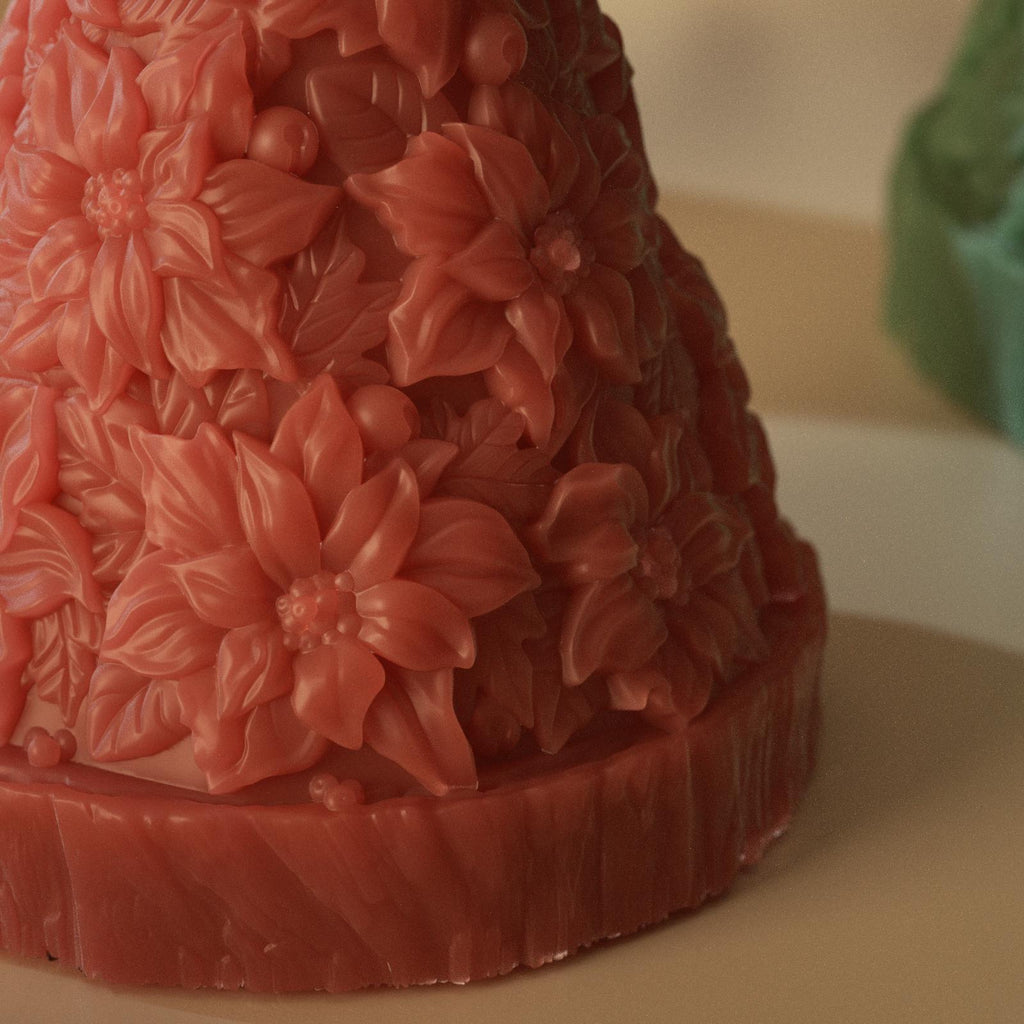 Close-up of red Christmas tree candle featuring detailed poinsettia flower texture - Boowan Nicole