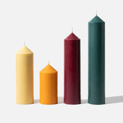 Pointed Pillar Candles in Four Colors on Plain White Background - Finished Product Display - Boowan Nicole