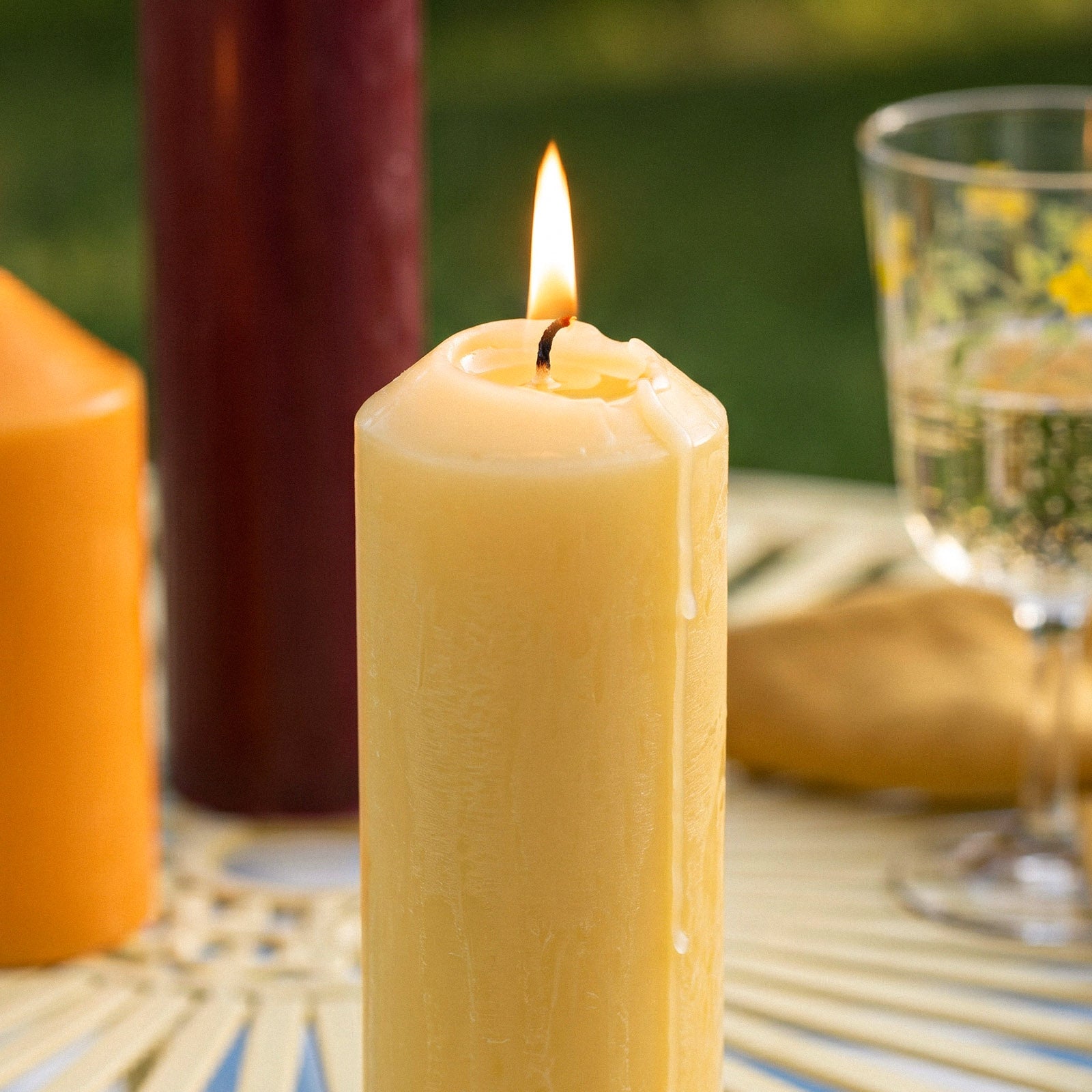 Close-Up of Lit Yellow Pointed Pillar Candle with Wax Dripping - Burning Effect Shot - Boowan Nicole