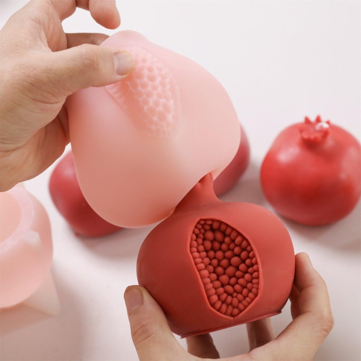 Unmolding a handcrafted pomegranate candle—showcasing clean release and detailed seed texture - Boowan Nicole