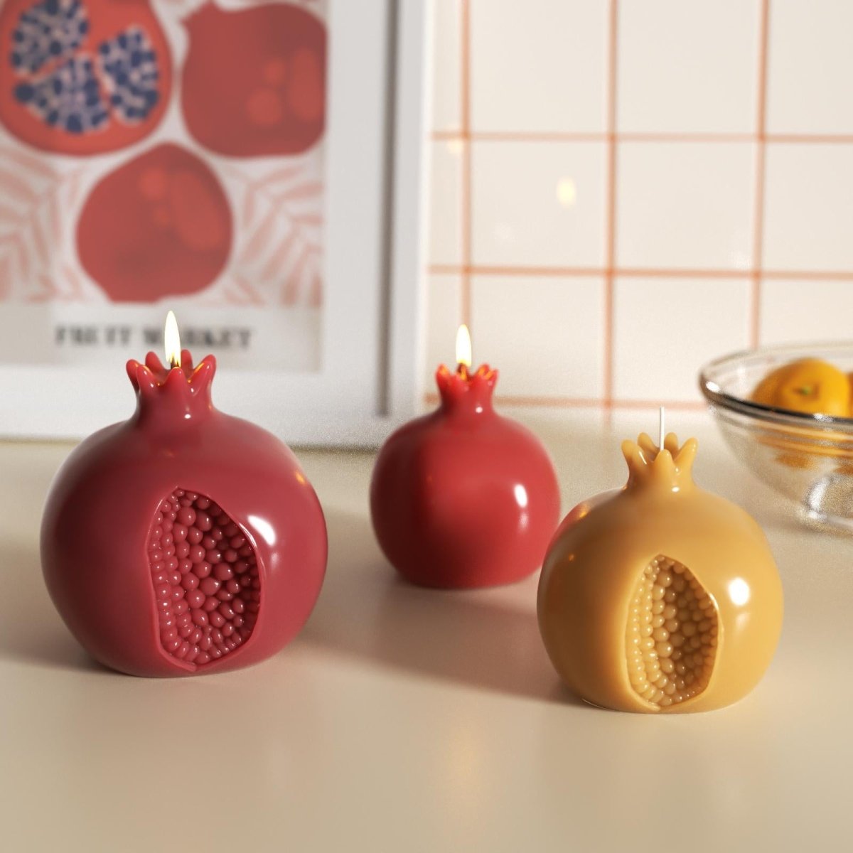 Glossy pomegranate-shaped candles lit and displayed on a tabletop—perfect for cozy home decor or festive ambiance - Boowan Nicole
