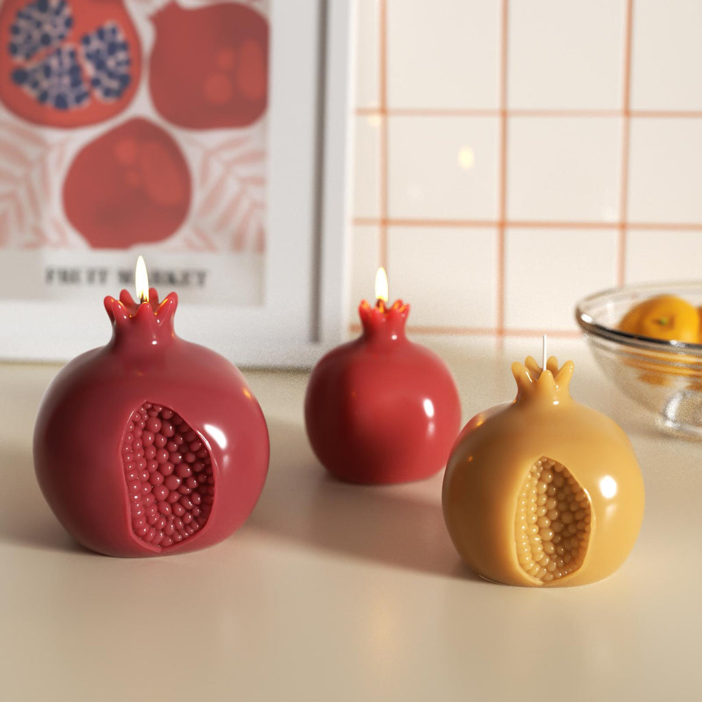 Glossy pomegranate-shaped candles lit and displayed on a tabletop—perfect for cozy home decor or festive ambiance - Boowan Nicole