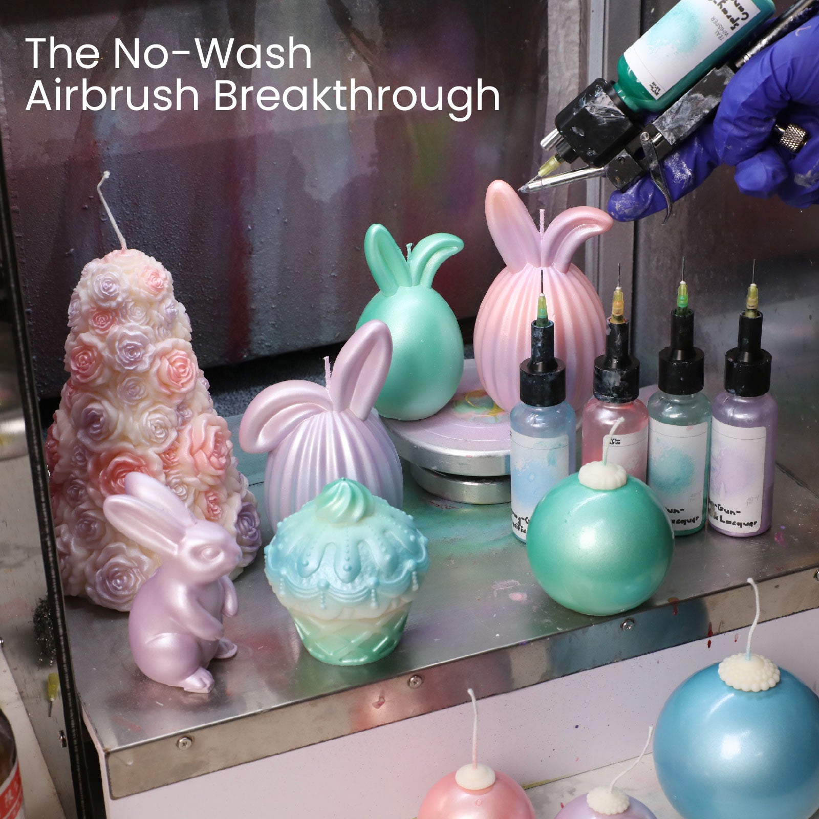 irbrushing pastel-colored candles with no-wash airbrush paint in a craft studio -Boowan Nicole