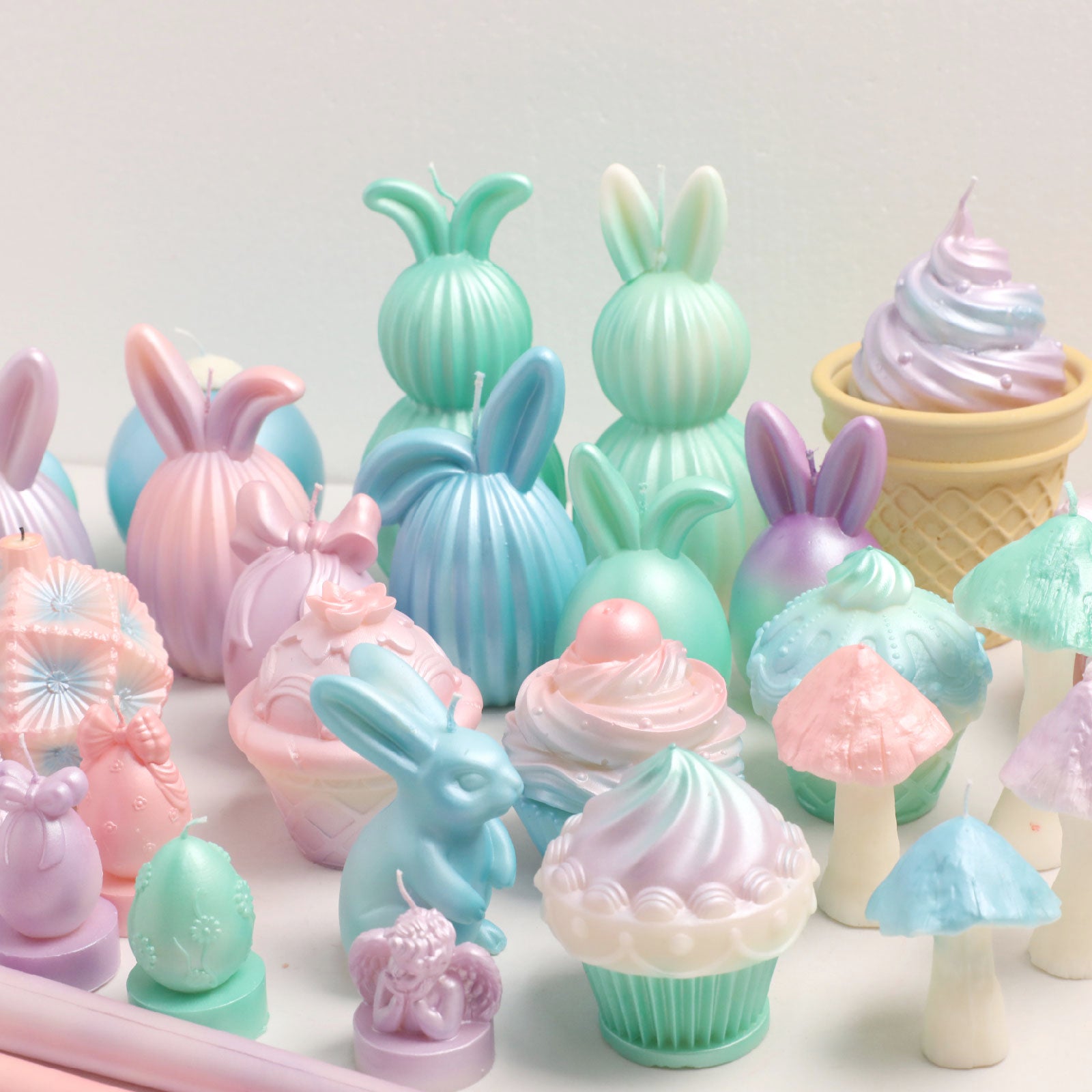 Vibrant assortment of pastel-colored bunny, cupcake, and mushroom-shaped candles -Boowan Nicole