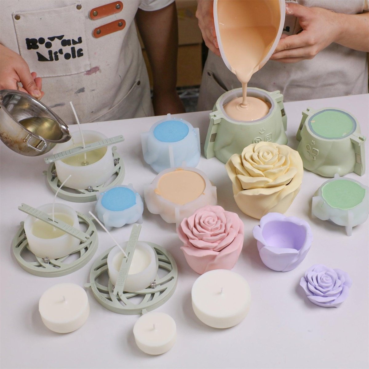Two people are simultaneously pouring concrete and wax, mass-producing rose-shaped candle jars and candle refill - Boowan Nicole
