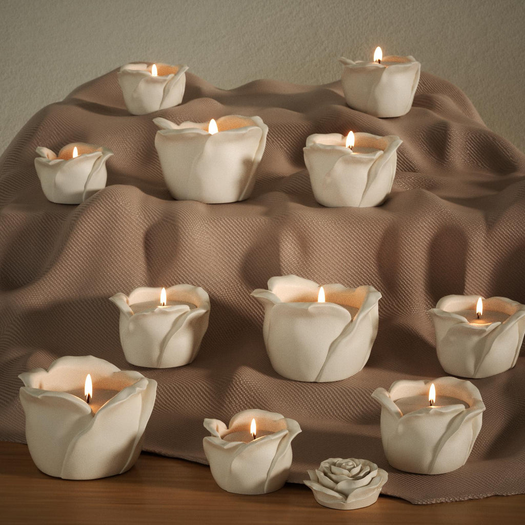 Multiple lit rose-shaped candle jars arranged on a layered fabric display, creating a warm and cozy atmosphere - Boowan Nicole