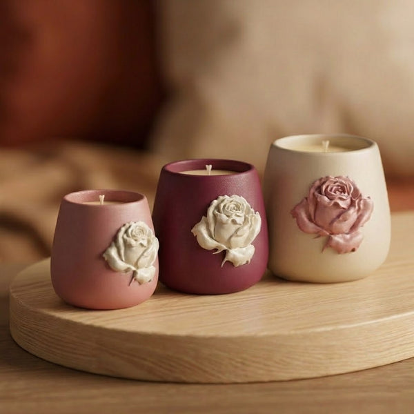 Three sized gradient-shaped rose relief candle jars displayed on a wooden tray with a warm blurred background - Boowan Nicole