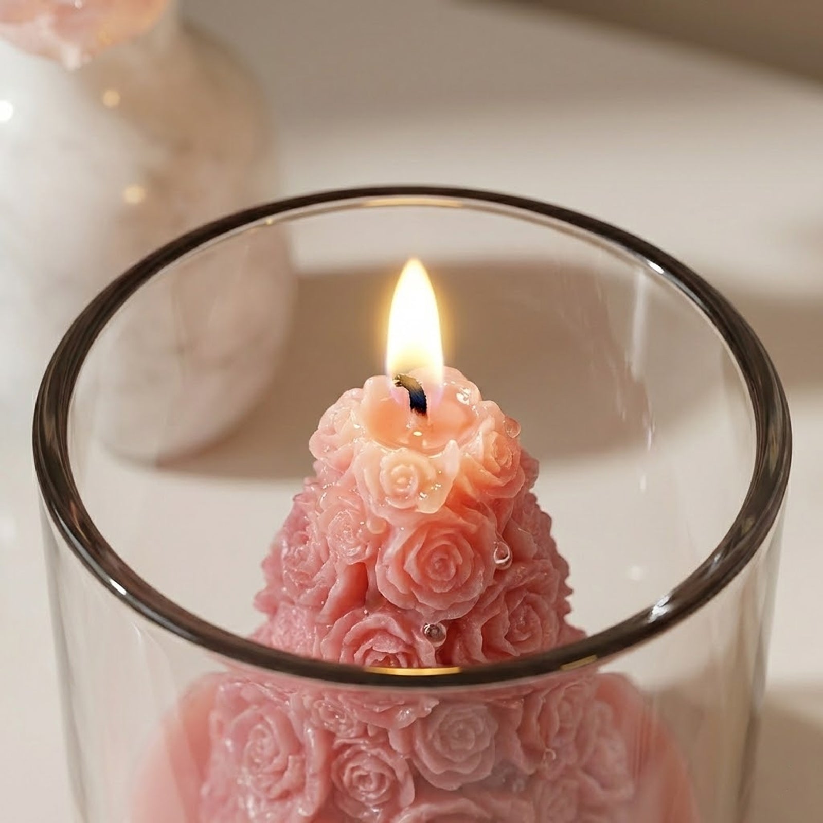 Close-up of Lit Pink Rose Tower Scented Candle - Boowan Nicole