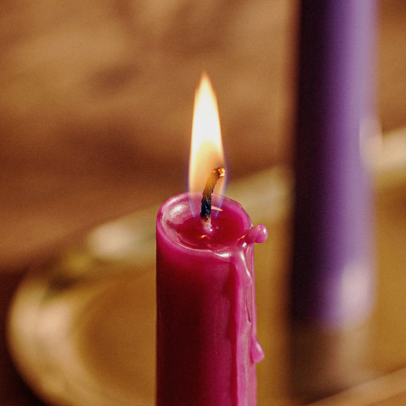 Round Top Taper Acrylic Candle Mold Collection, close-up of lit red taper candle with melted wax and dripping - Boowan Nicole