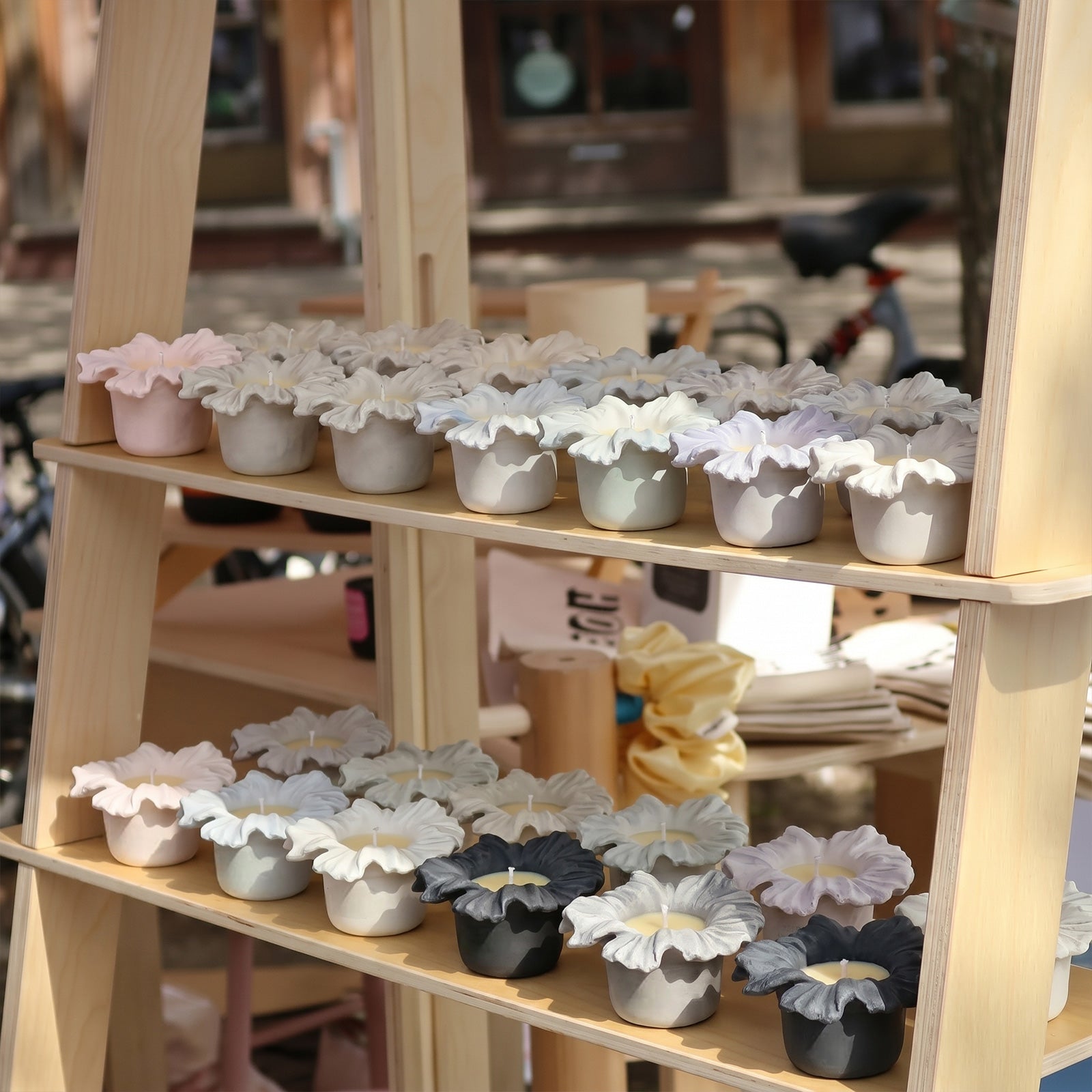 Colorful Sea Anemone Bloom Candle Jars displayed on a wooden shelf at a craft market - Boowan Nicole