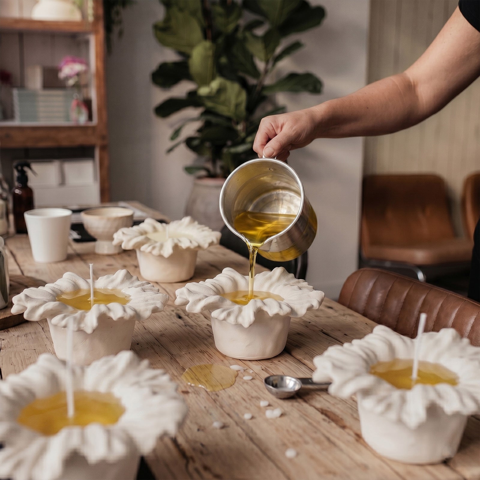 Pouring melted wax into handmade Sea Anemone Bloom Candle Jars - Boowan Nicole