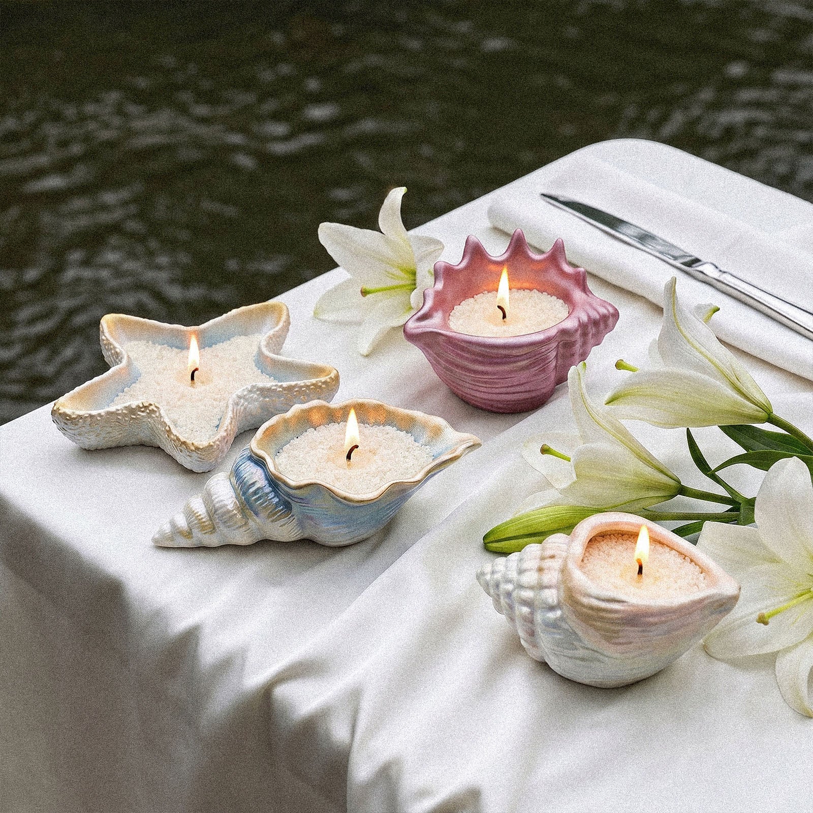 Dinner Table Styling with Iridescent Conch Starfish Sand Wax Candles and Fresh White Lily Decor - Boowan Nicole