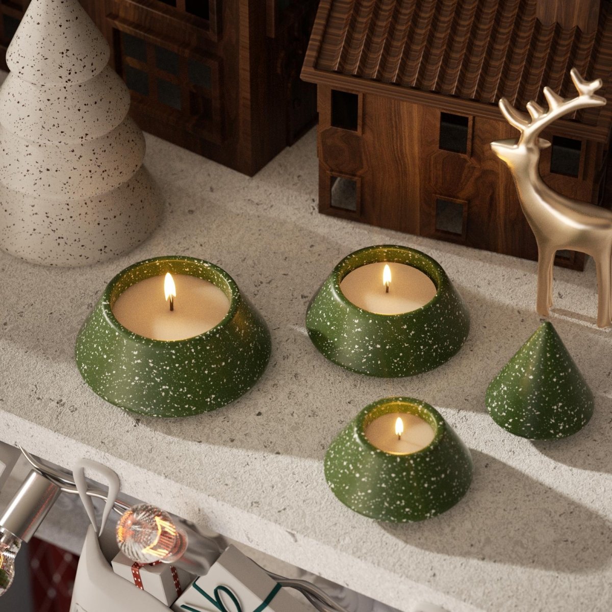 Handmade green terrazzo stacking Christmas tree candle jars with lit candles on a festive mantel - Boowan Nicole
