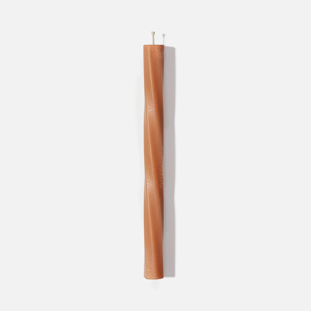 Serene Twist taper candle — slender spiral taper in terracotta on a white background - Boowan Nicole