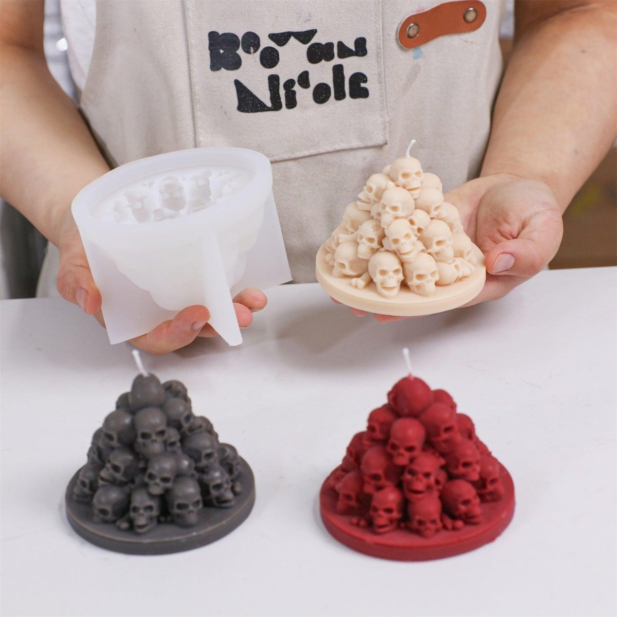 Demolding a flesh-toned Skull Mountain candle from the silicone mold- Boowan Nicole