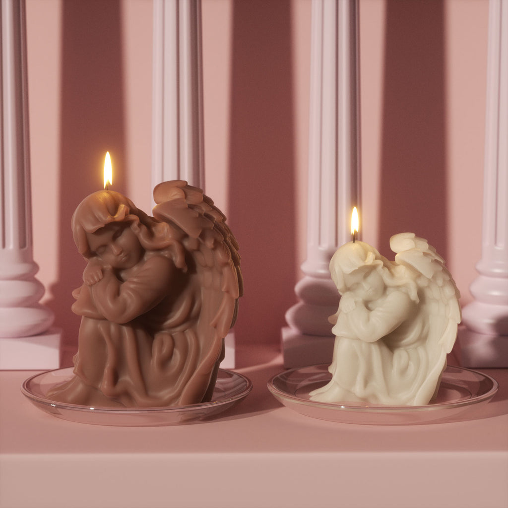 Cocoa-brown and ivory sleeping angel pillar candles lit on glass plates - Boowan Nicole