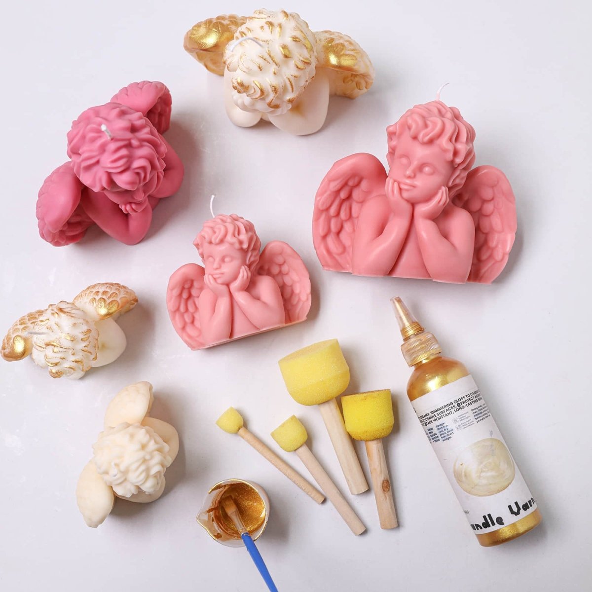 Sleeping Angel cherub candles in pink and ivory with wings—gold accents, sponge brushes, and bottle of gold candle varnish for DIY painting - Boowan Nicole