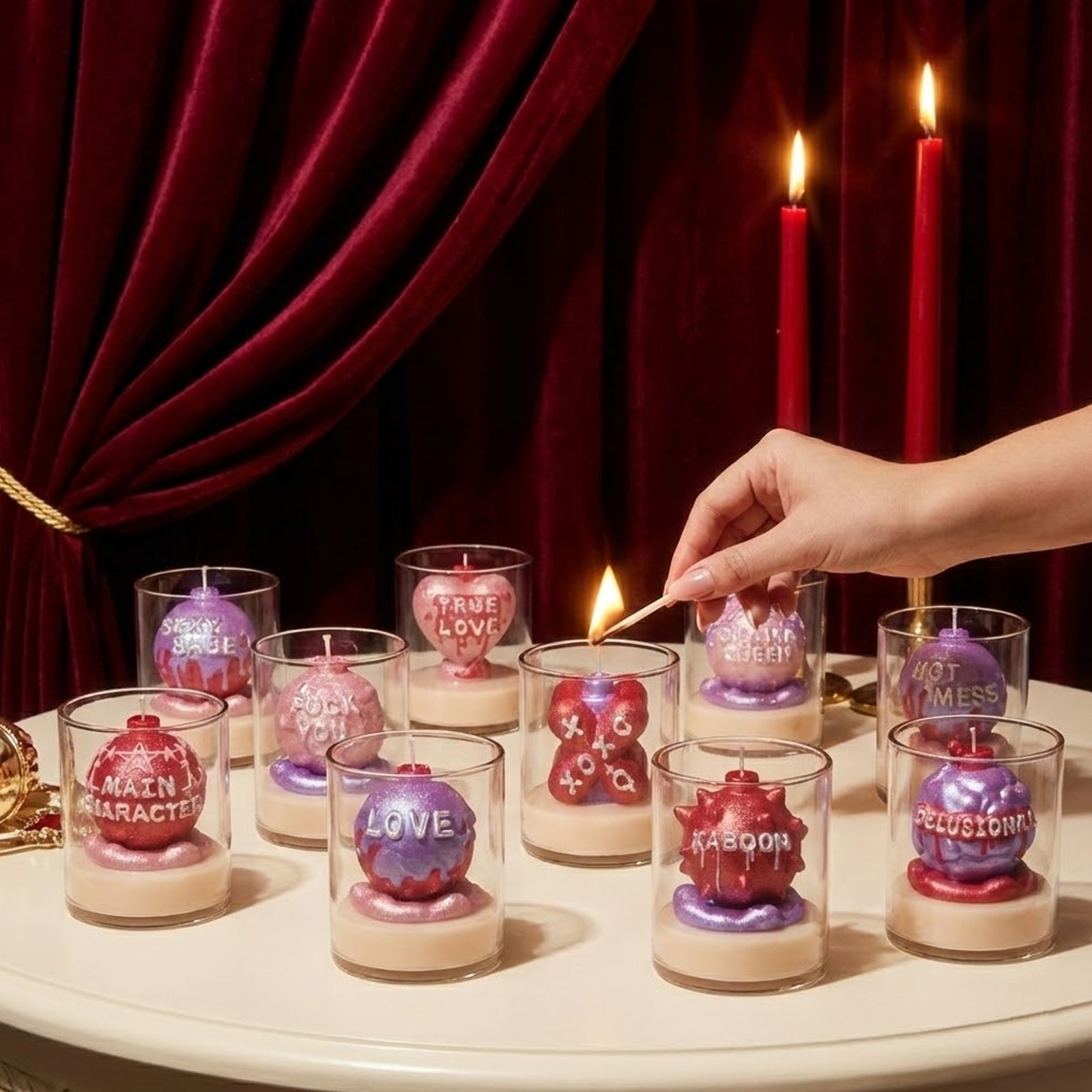 Hand lighting a sparkly 3D quote candle from the Large Boomy Love collection in glass jars, featuring sassy slogans - Boowan Nicole