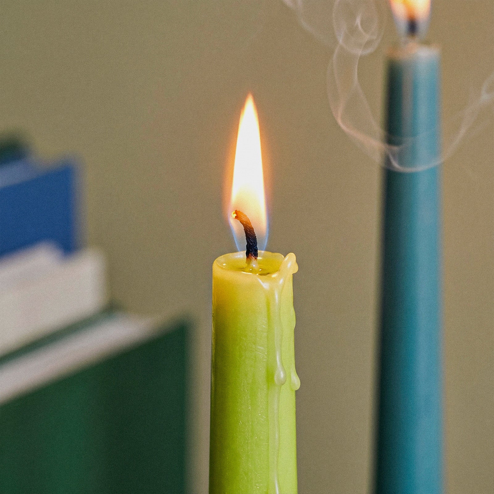 Smooth Taper Acrylic Candle Mold, close-up of lit green taper candle with melted wax drips - Boowan Nicole
