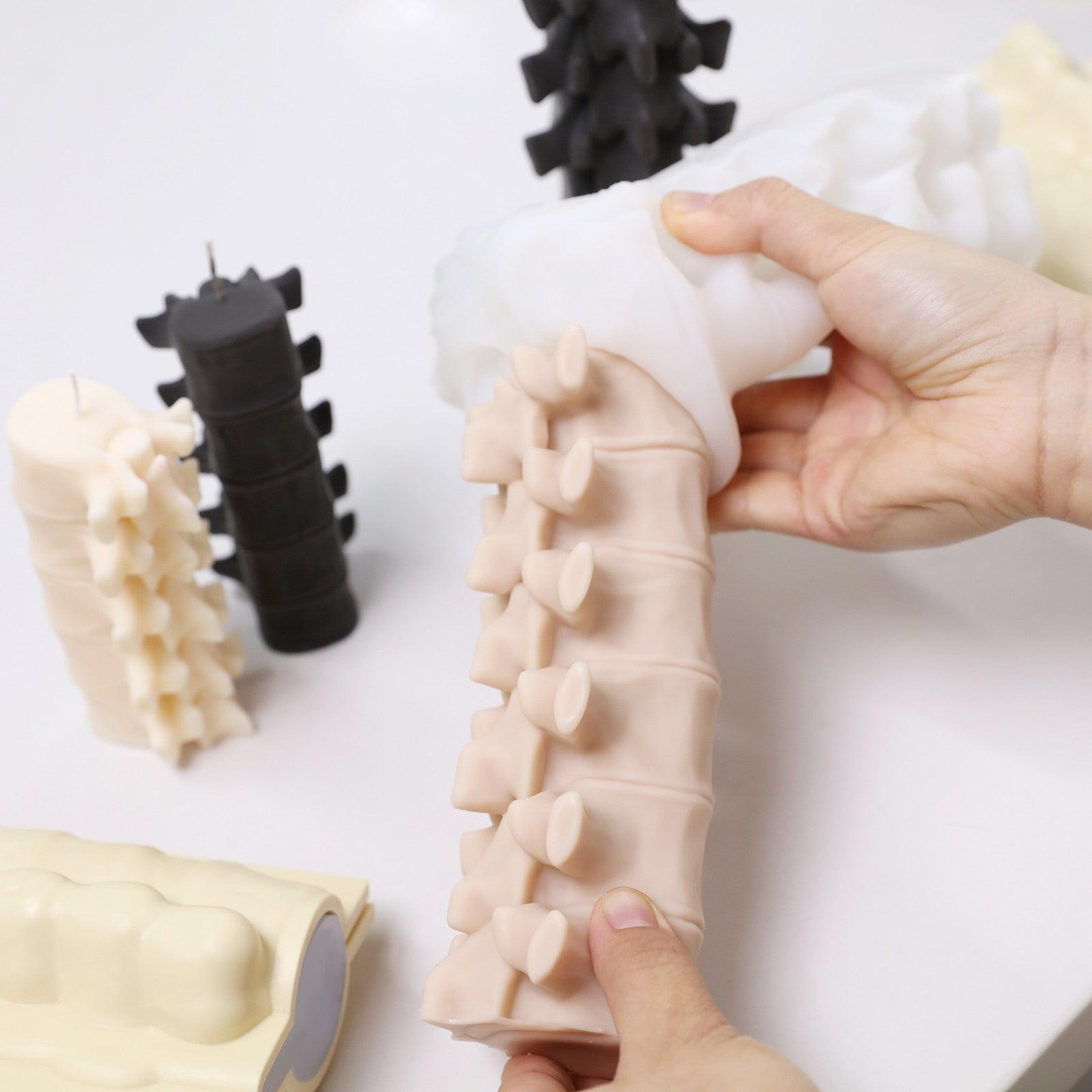 Demolding spine-shaped candles from flexible silicone molds for small batch handmade production - Boowan Nicole