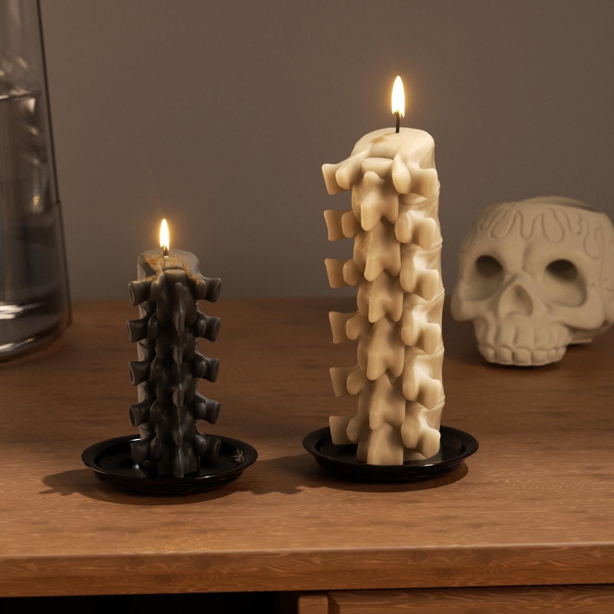 Black and beige spine-shaped candles burning on black trays, creating a spooky gothic atmosphere - Boowan Nicole