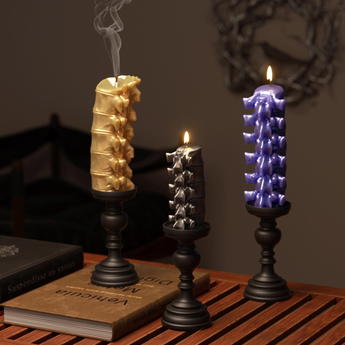 Three spine-shaped candles in gold, black, and purple on black candle holders, Halloween decor setup - Boowan Nicole