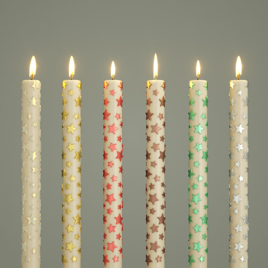 Six taper candles with raised star patterns in metallic colors, all lit and arranged in a row for festive display - Boowan Nicole