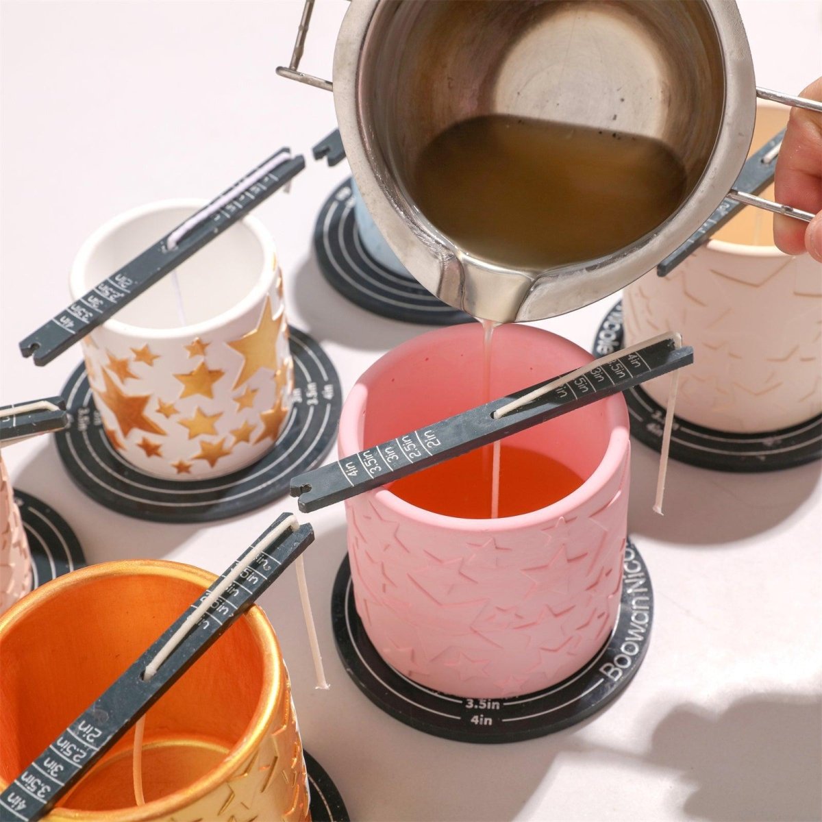 Pouring melted wax into a handcrafted pink star-shaped concrete candle jar for home decor-Boowan Nicole