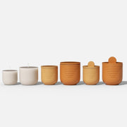 Set of gradient orange and beige geometric candle jars with lids, displayed in various sizes on white background - Boowan Nicole