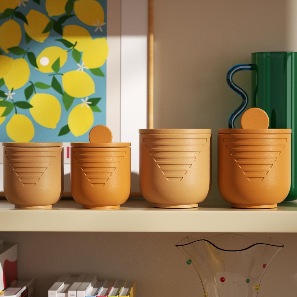 Four orange geometric candle jars with lids displayed on a shelf, styled with books, art, and glassware - Boowan Nicole