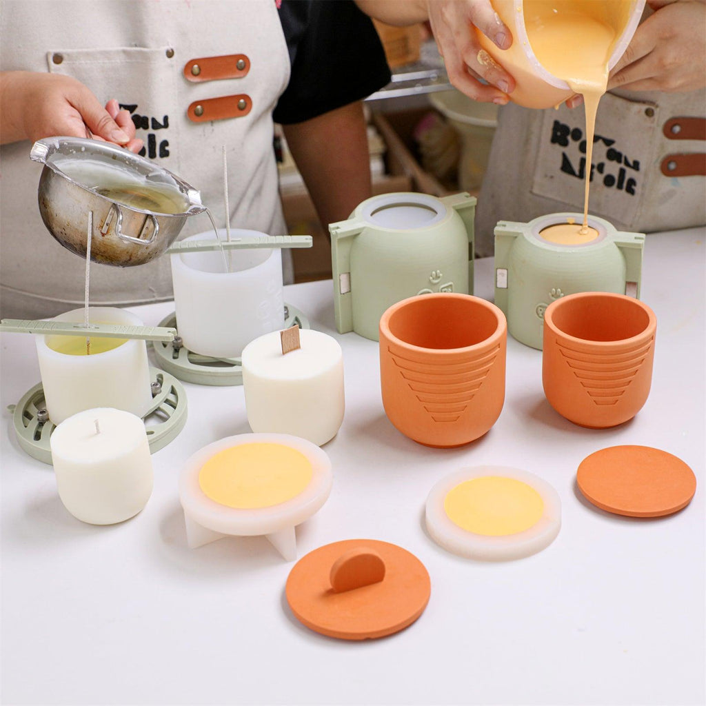 Pouring mixed concrete pigment and melted wax into silicone molds for candle jars and refills - Boowan Nicole