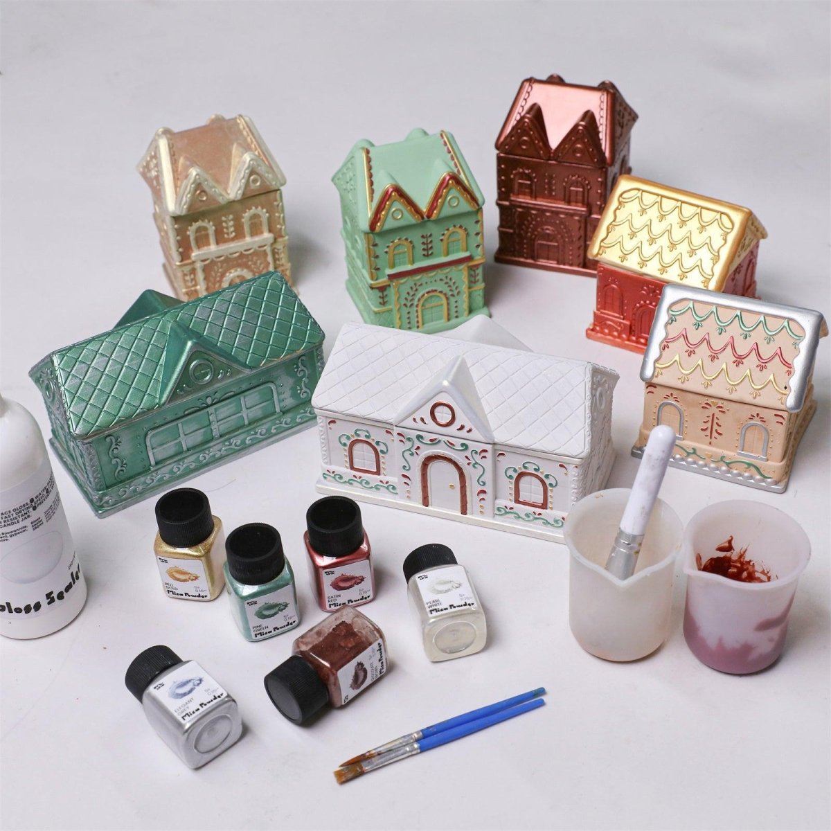 Christmas gingerbread candle jars with christmas glitter sealer varnish and hand-painting setup for festive DIY crafting - Boowan Nicole