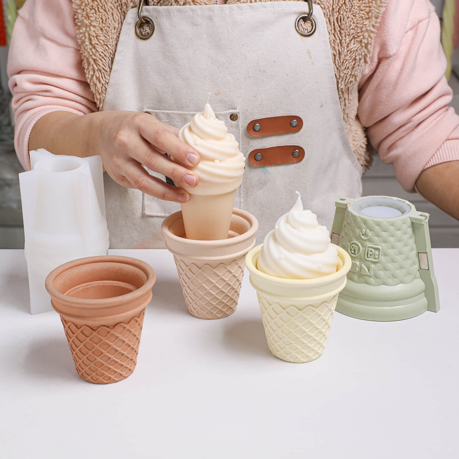 Crafter placing a soft-serve ice cream cone swirl candle into waffle - Boowan Nicole