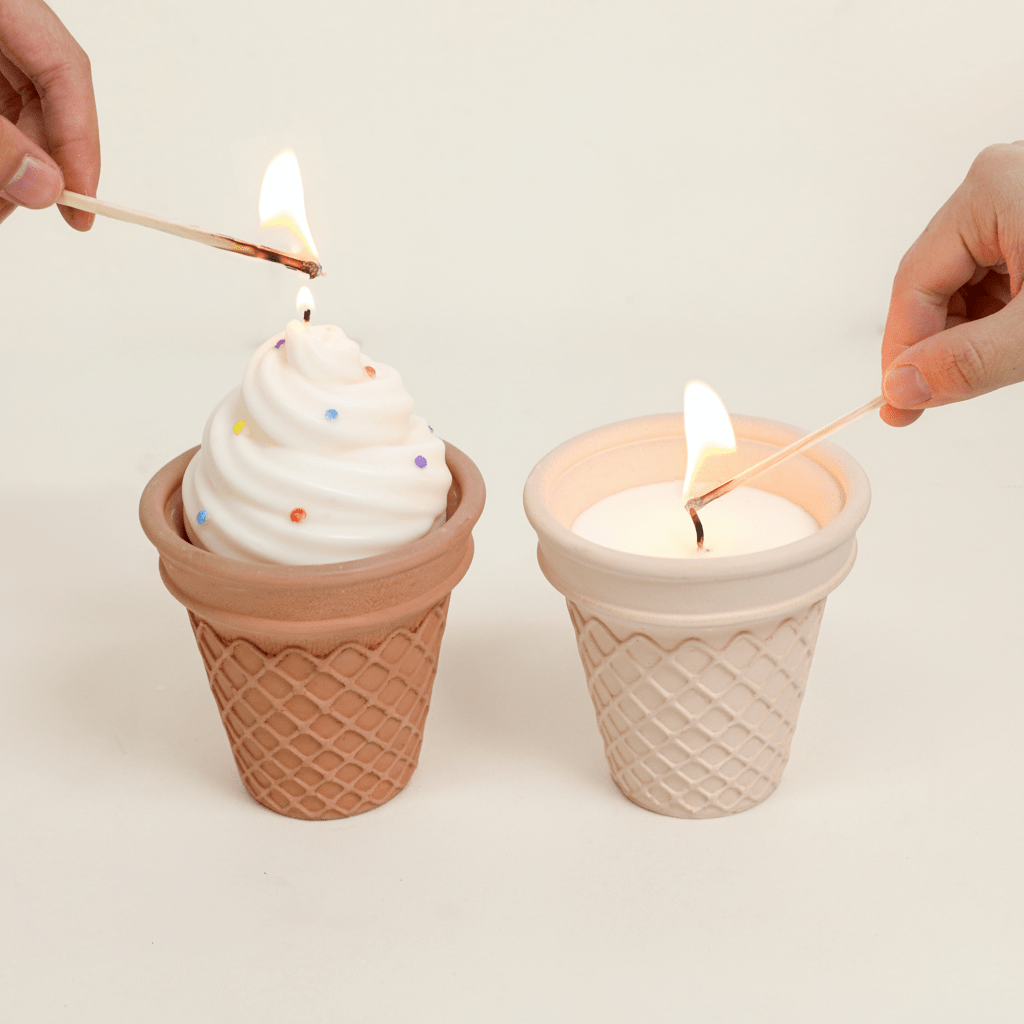 Hands lighting two waffle-cone candles—one soft-serve swirl with rainbow sprinkles and one flat-filled candle—in Sweet Swirl Sundae jars  Boowan Nicole