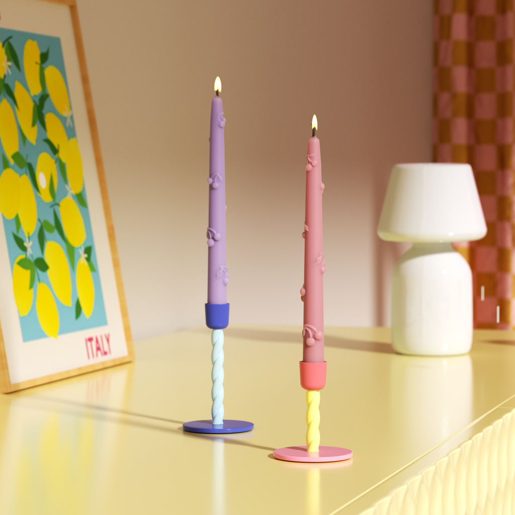 Two cherry taper candles burn slowly in matching colorful candlesticks to add a relaxing touch.