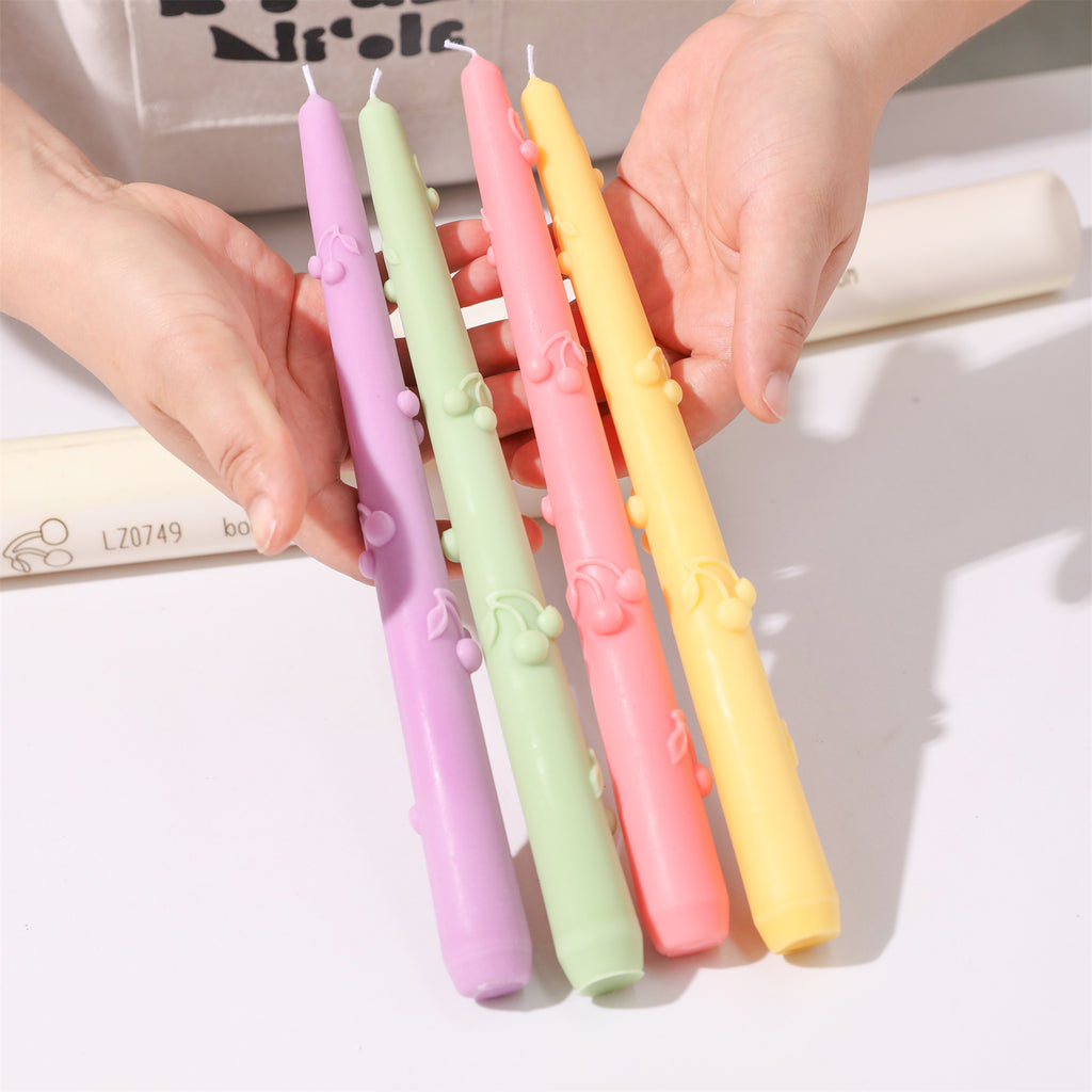 Unmoulded Cherry Sprinkle taper candles in different colors.